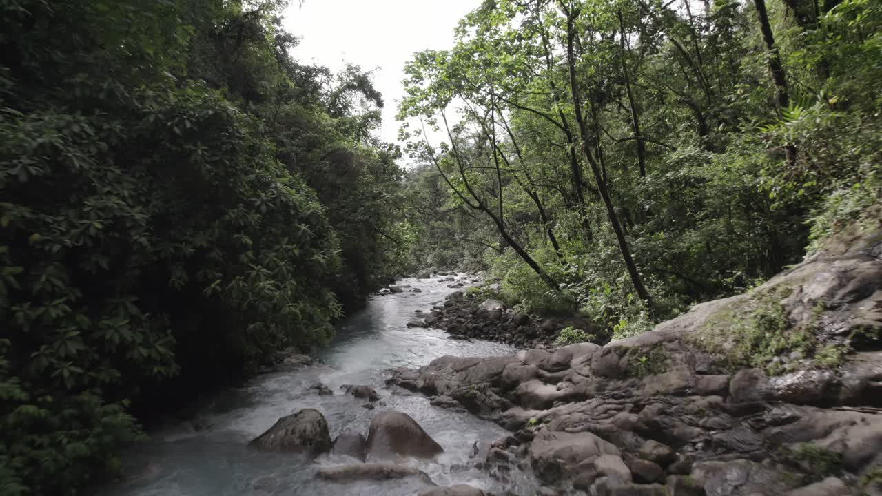 Close-up perspective of the mesmerizing Rio Toro river that flows from the Las Gemelas Waterfalls in Costa Rica