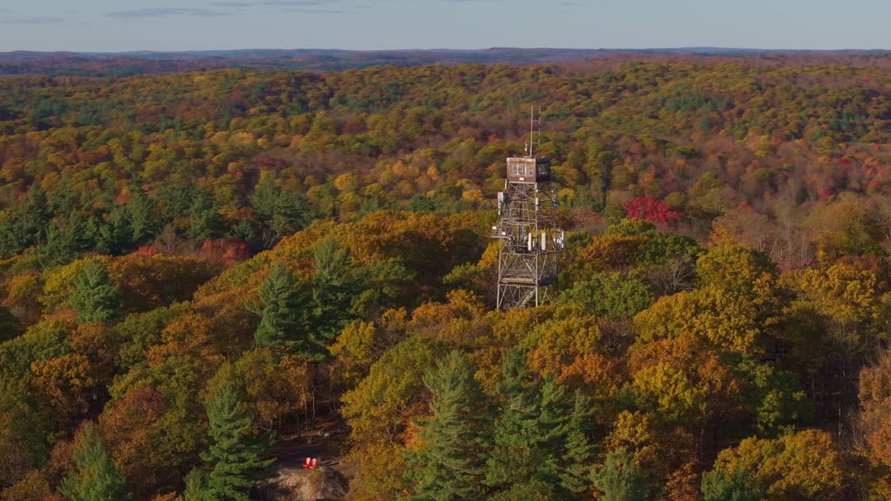 Dorset lookout tower surrounded by vibrant fall foliage in ontario, canada, aerial view