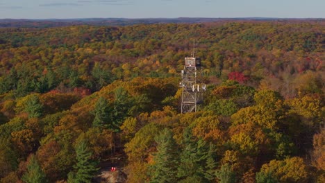 dorset lookout tower surrounded by vibrant fall foliage in ontario, canada, aerial view