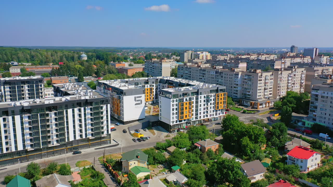 New apartment houses. Modern district in big town. Aerial panoramic video. Colorful bright high-rise buildings.