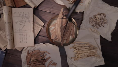 traditional chinese doctor medicine working classification and preparation with herb and species mushroom anise turmeric in a table for traditional medicine advertising