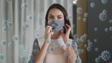 animation of virus cells over caucasian woman with face mask