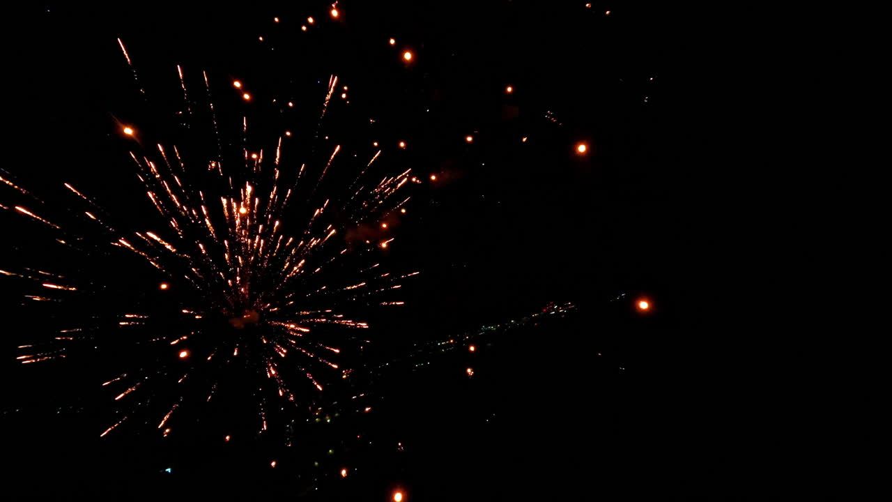 Aerial view of colorful fireworks in night sky, celebrating festivity