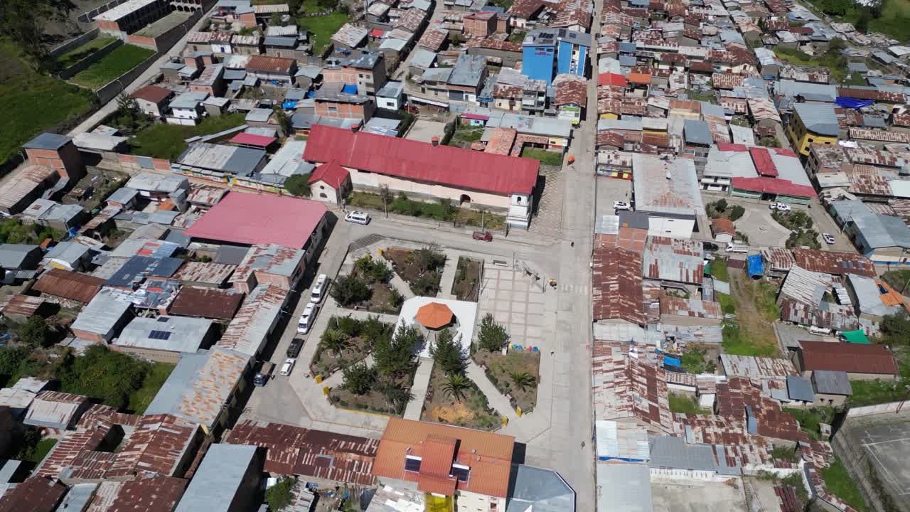 Aerial orbits quiet empty small town plaza, Cajatambo Peru mountains