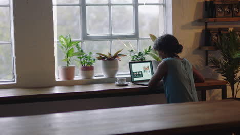 successful black business woman using laptop computer working late on project document browsing online research brainstorming ideas for small business planning strategy in cafe