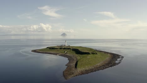 Aerial-view-of-Pladda-Lighthouse-on-the-Isle-of-Arran-on-a-sunny-day,-Scotland