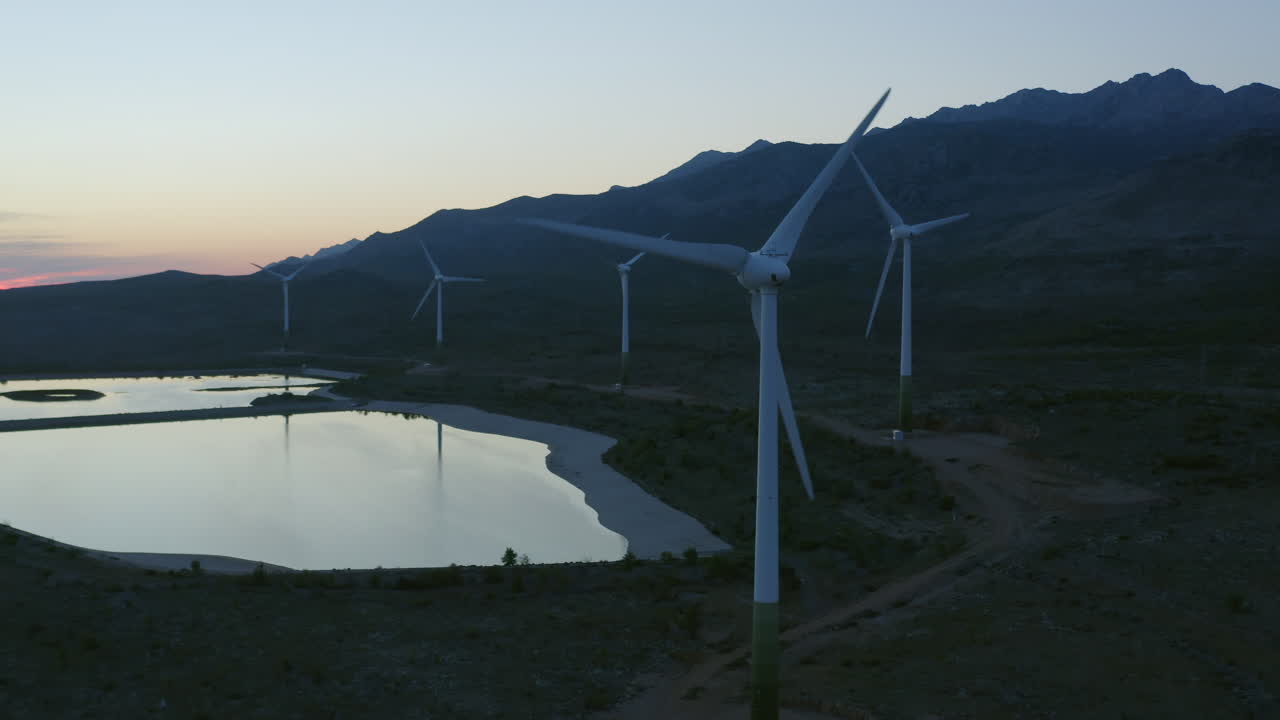 Wind Farm at Sunrise/Sunset over Mountain Lake