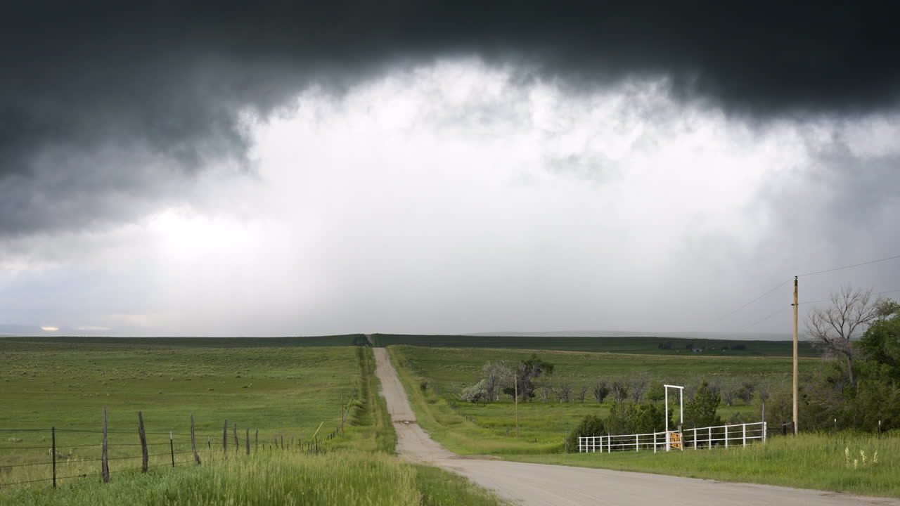 Country Road And Rolling Hills As Dark Textured Clouds Move Over Head