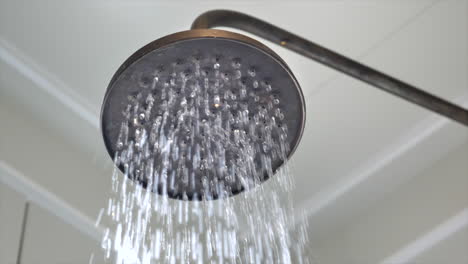 Close-up-of-water-running-from-a-shower-head