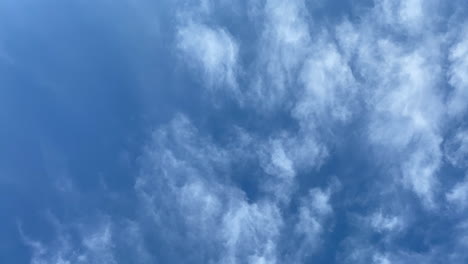 time-lapse of a deep blue sky with white whispy clouds