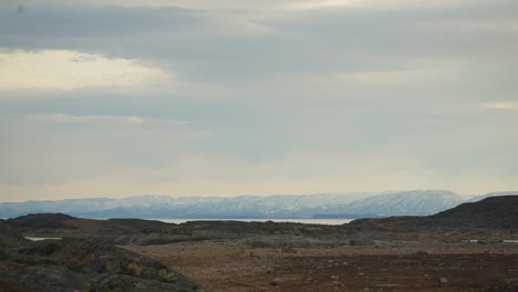 cloudy sky over a tudnra plain by the ocean