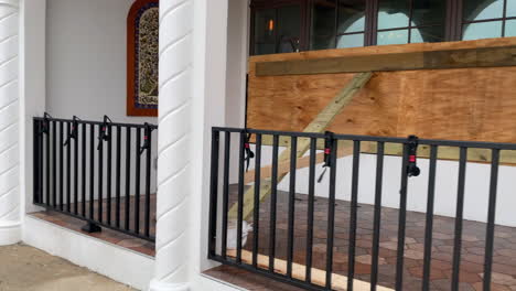 Restaurant-boarded-up-with-sandbags-preparing-for-hurricane-flood-waters