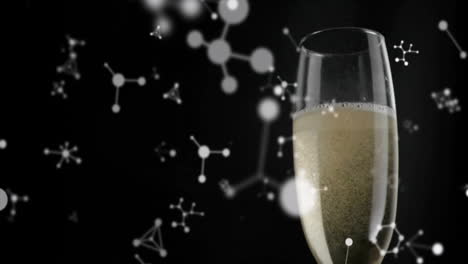 animating molecular structure over champagne glass on black background