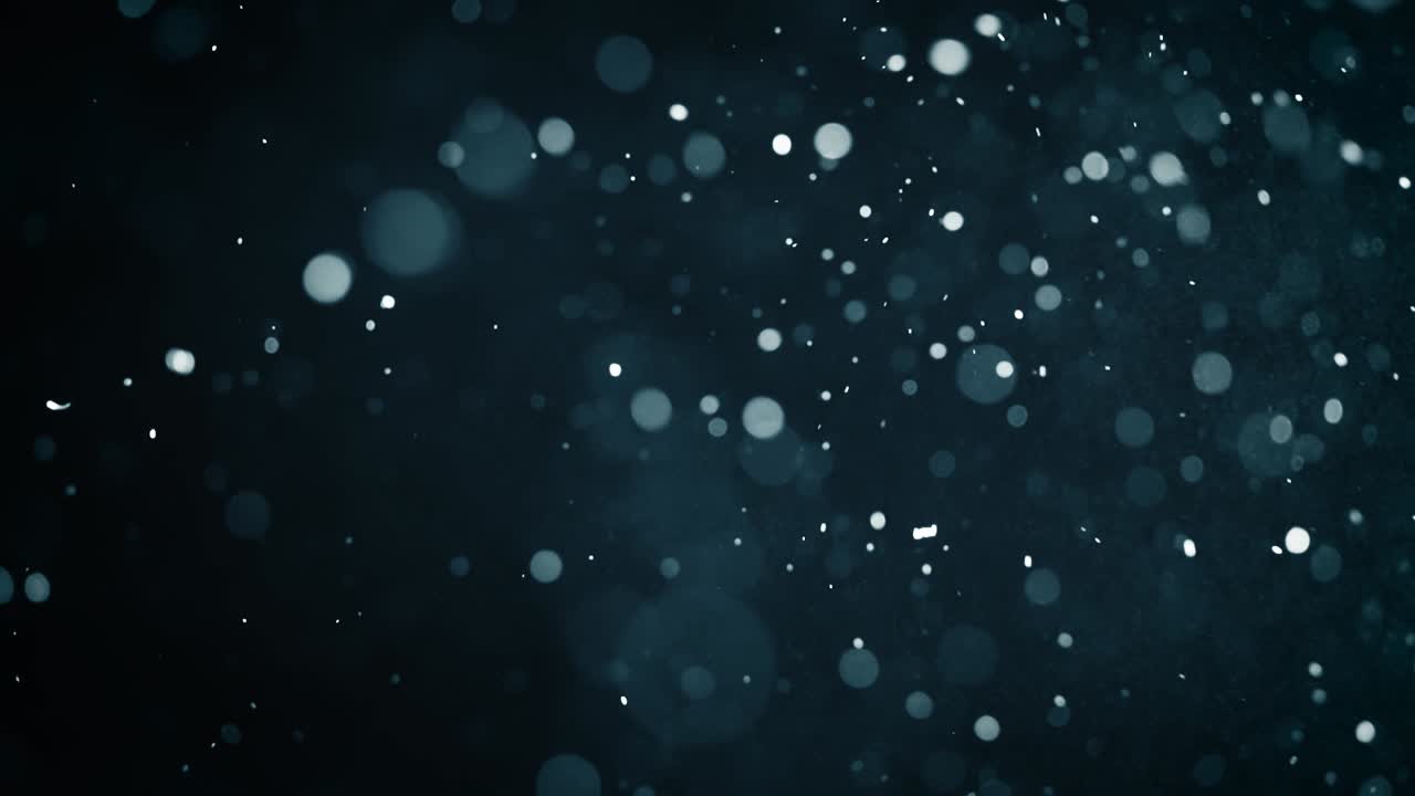 bokeh di particelle astratte galleggianti su sfondo scuro