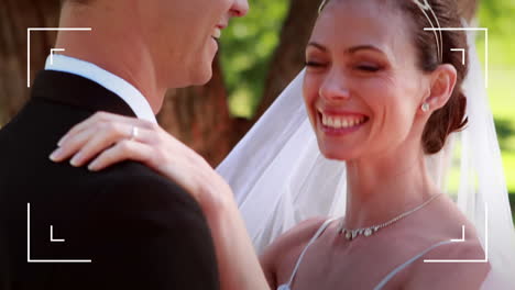 animation of camera interface over happy bride and groom on wedding day