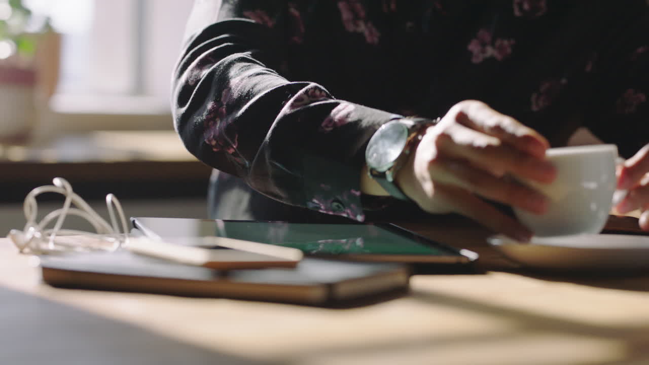 close up young man hands using digital tablet computer in cafe drinking coffee browsing social media messages on touchscreen device enjoying mobile communication technology