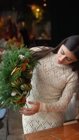 woman making a beautiful christmas wreath