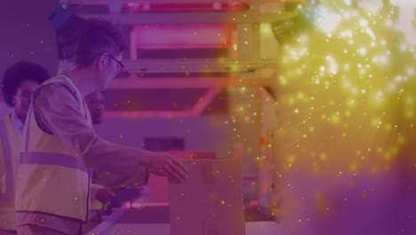 Animation-of-glowing-lights-over-asian-man-working-in-warehouse