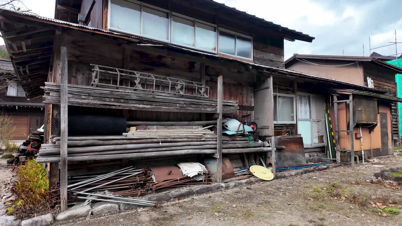 Scaffolding equipment and wood material lying outdoor near traditional Shirakawa Go houses, Japan