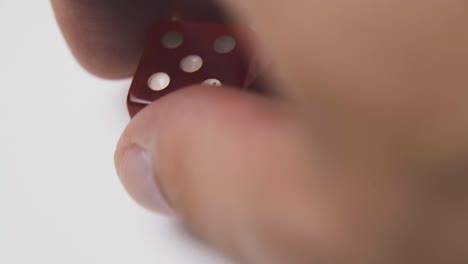 hand-throws-beautiful-dices-with-spots-on-light-background