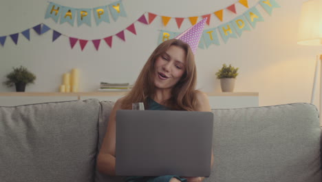 woman celebrating birthday via video call