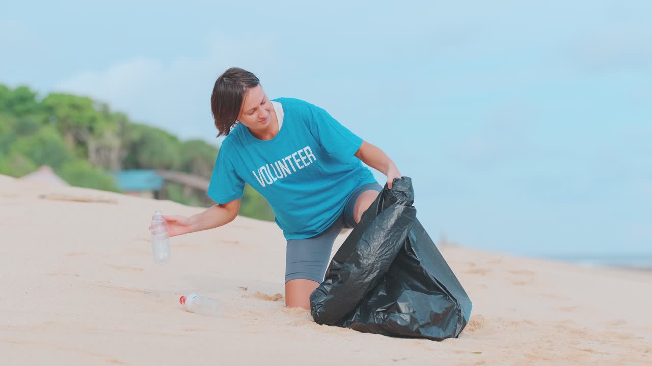 Young caucasian woman removing garbage and throwing bottles from beach