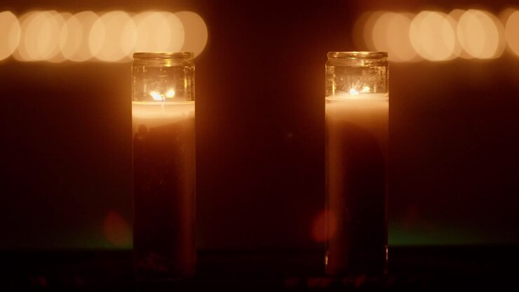 Candles fading to black in dark cave