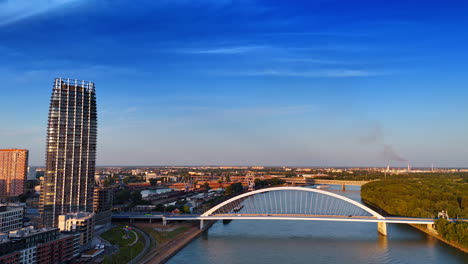 the appolo bridge over the danube in bratislava, slovakia. modern scenery of the city at sunset time