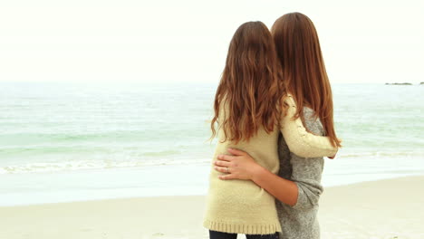 mother and daughter looking at beach