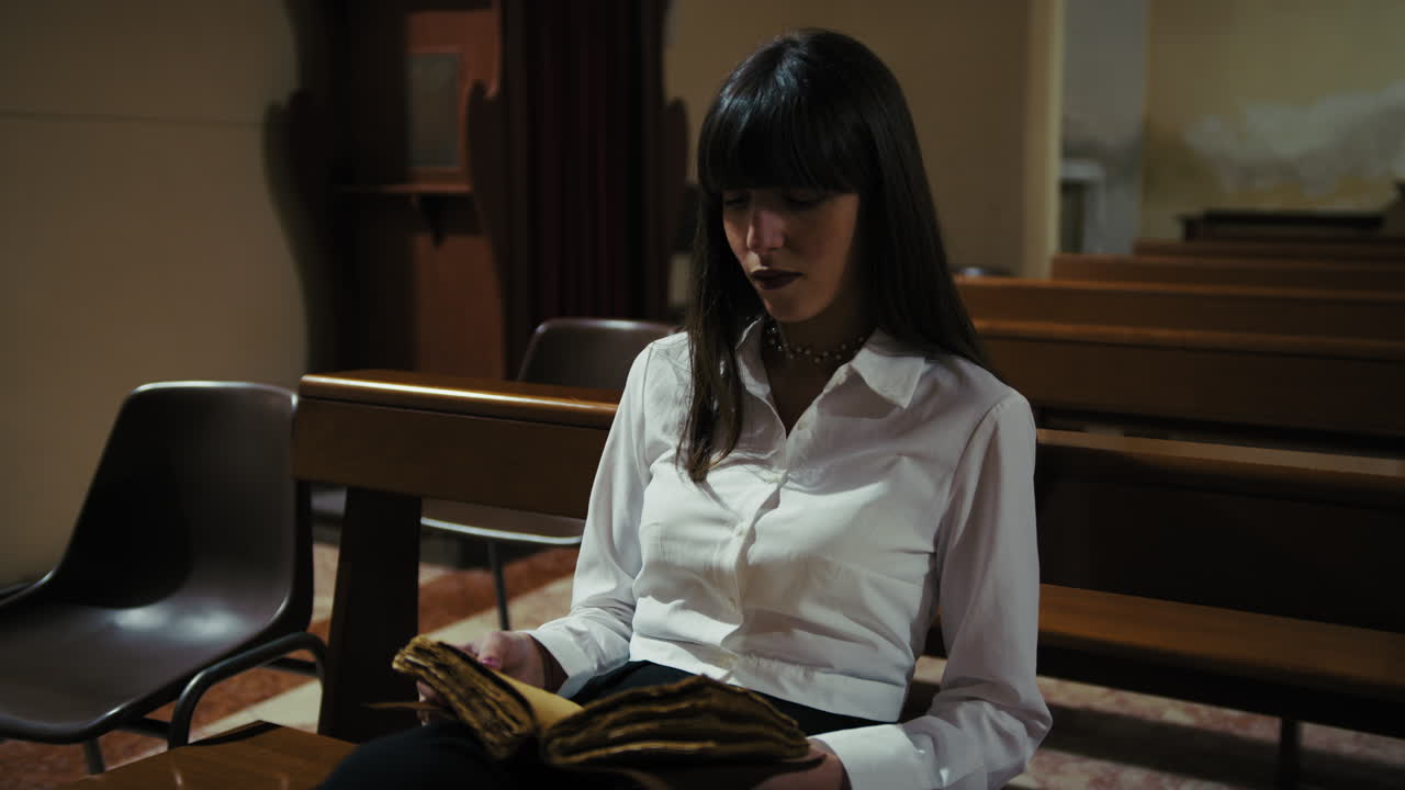 Woman Flipping The Pages Of The Old Sacred Book While Sitting In The Church