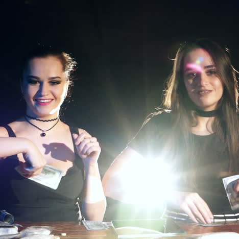 happy ladies throwing money up, celebrating a successful victory with a lot of dollars. criminal business. slow motion