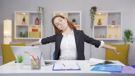 home office worker woman yawns and relaxes at the camera.