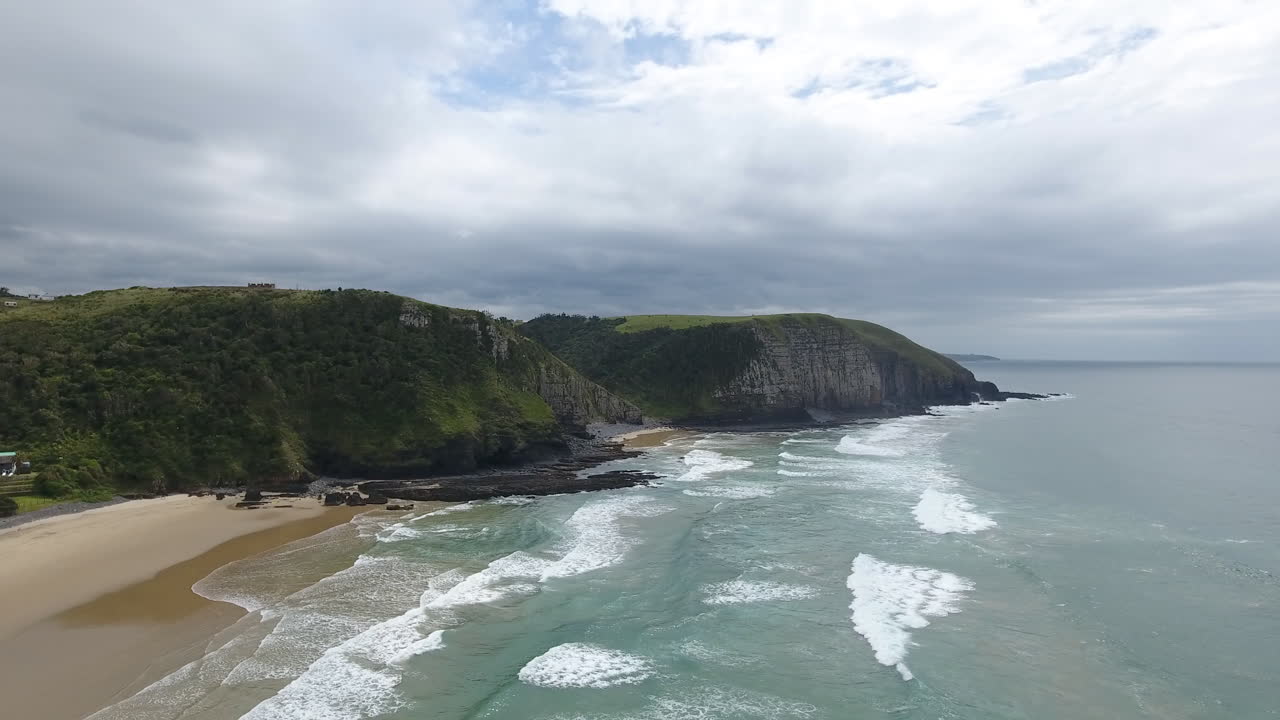 Cinematic aerial flying along coast of East London South Africa