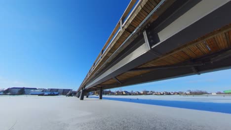 the bridge was trapped by the ice of a frozen river on a sunny summer day