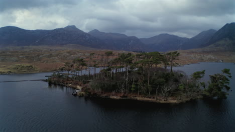 aerial pullback of pine island at twilight, connemara national park, ireland