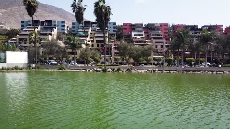 Drone-shot-of-hills-and-apartments-in-a-lake-in-the-city-of-Lima-Peru