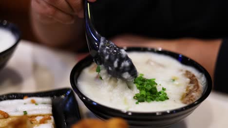 savoring a bowl of rice porridge