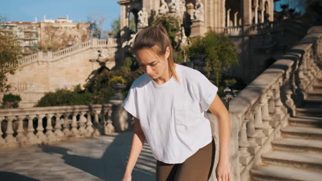 Caucasian-sporty-woman-doing-kick-ups-with-ball-outdoors.