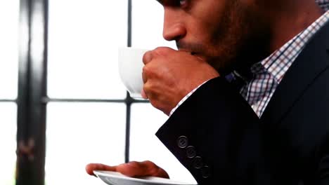close-up of businessman drinking cup of coffee