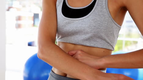 slim woman measuring her waist