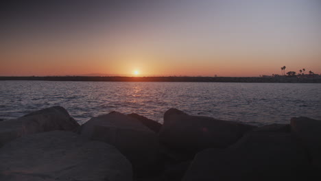 purple and orange sunset over a pacific channel