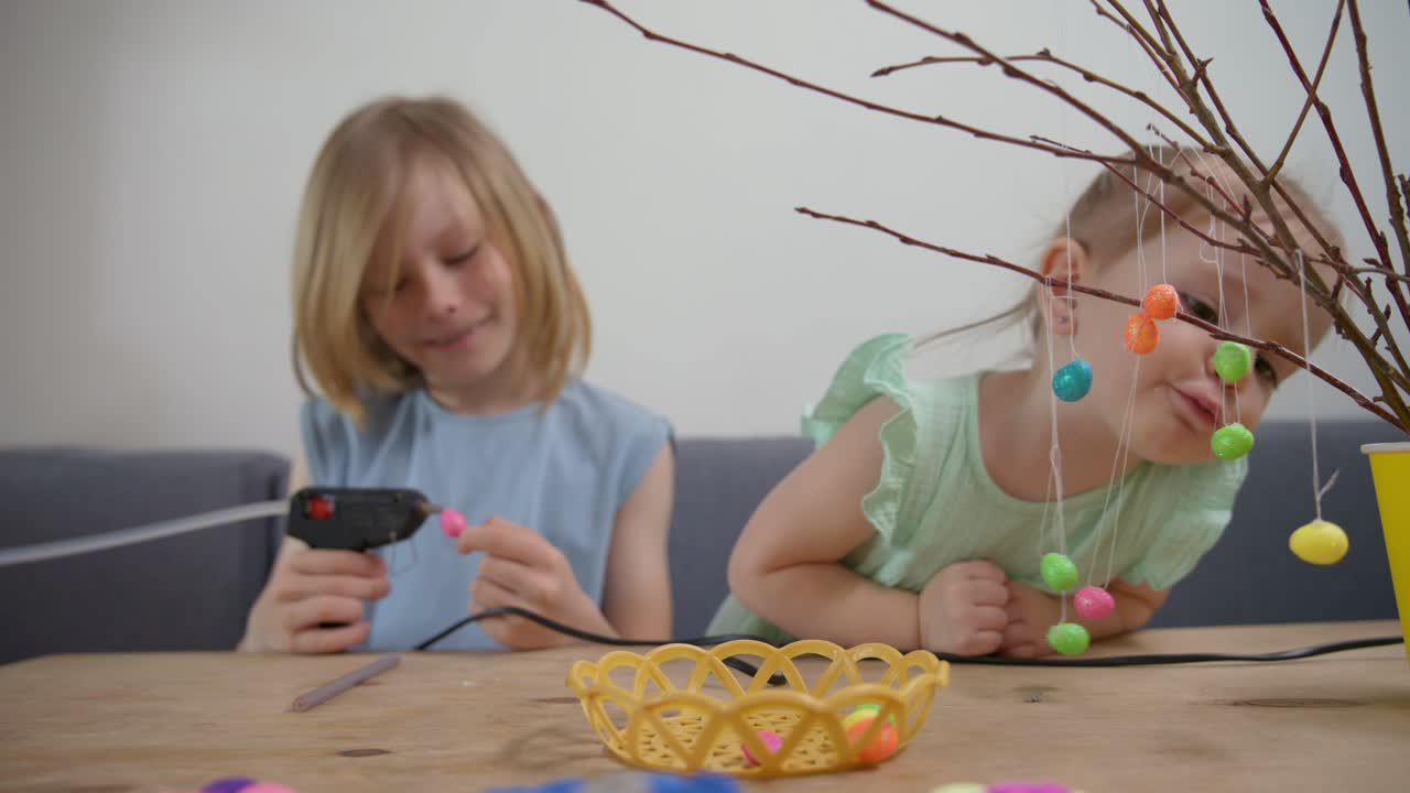Two Young Girls Decorating Easter Eggs Together