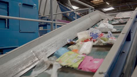 sorting conveyor belt moving upwards caring out the waste materials, mostly paper and plastic