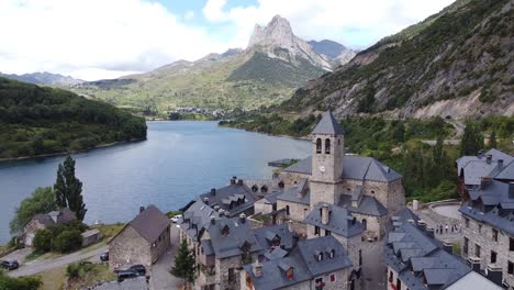 lanuza at tena valley, huesca, aragon, spanish pyrenees, spain - aerial drone view of the mountain village and dam lake embalse de bubal