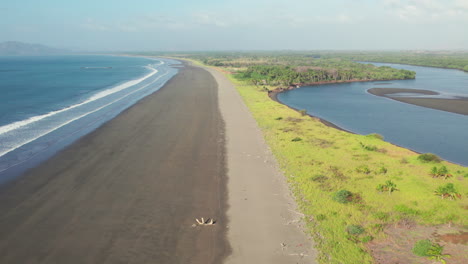 Aerial-shot-along-the-empty-black-sand-beaches-at-Canas-Island