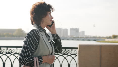 mature woman talking on phone outdoors