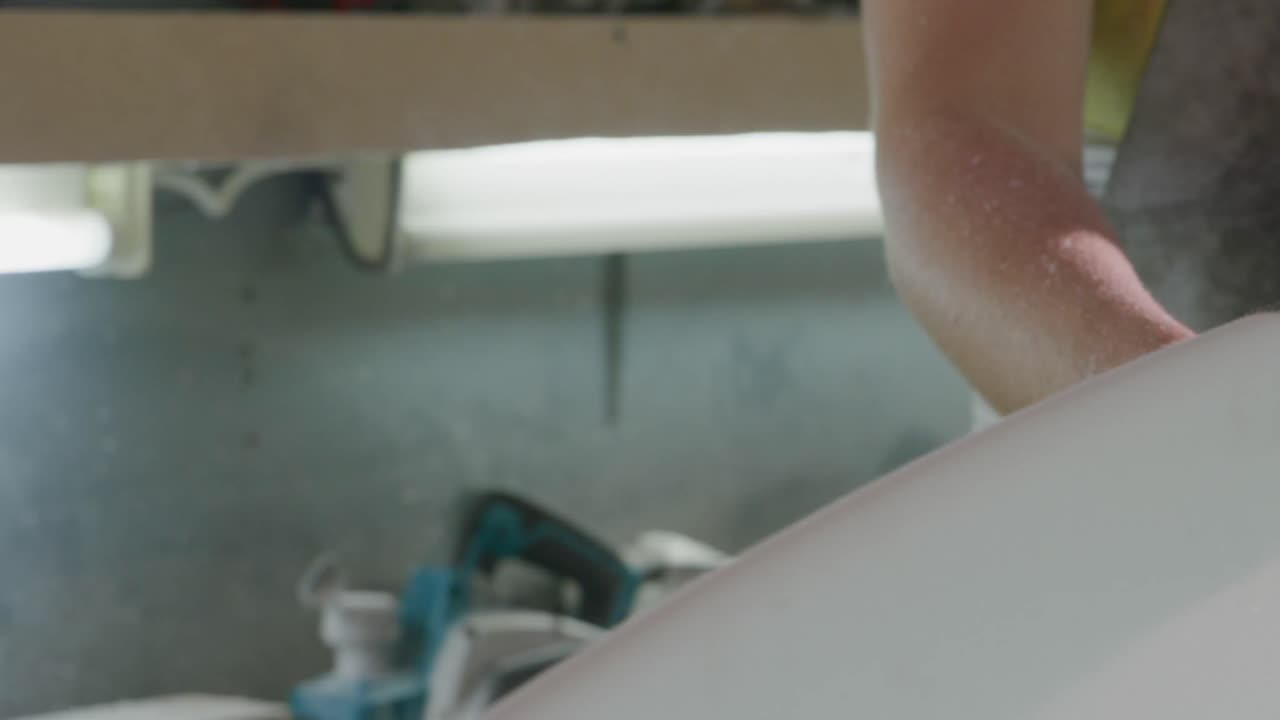 Male surfboard maker in his workshop
