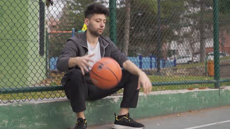 young man alone on the basketball court.