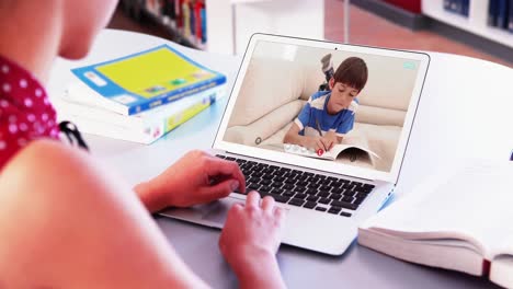 Caucasian-female-teacher-using-laptop-on-video-call-with-schoolboy