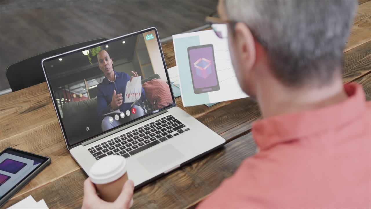 Caucasian businessman on laptop video call with african american male colleague on screen
